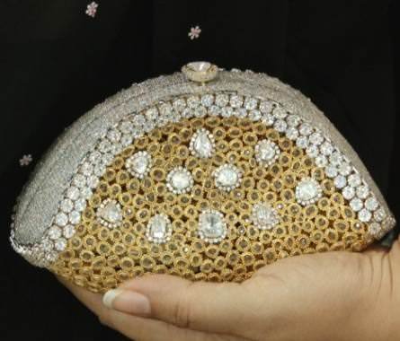 A 14K gold and diamond clutch by CVM Jewellery