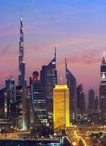 The DWTC tower is part of the modern skyline of Dubai, with the world's tallest building in the background.
