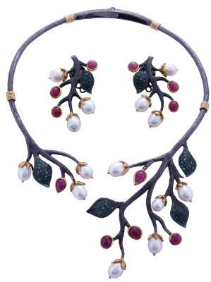 Gemstone, pearl, and silver earrings and necklace by Dhevan Dara.