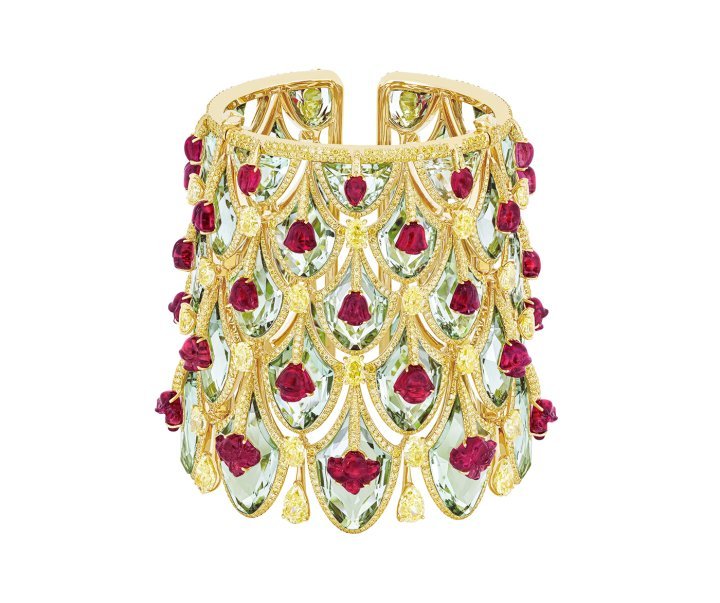 The Winter Roses cuff draws its inspiration from the Rose Gate of Jaipur's City Palace; a tribute to the Goddess Devi and the winter season. Carved rubellite flowers are set atop sea-green prasiolites, using the Kissing technique, while pendants of yellow diamonds are held beneath. ©Boghossian