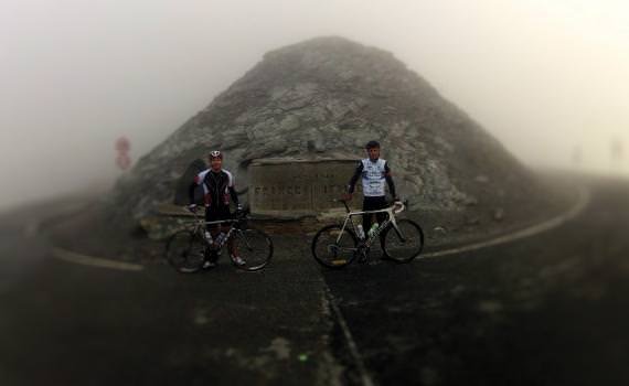 Two members of the convivial group of 23 riders who set off from Alpignano, Italy on the five-day Turin to Monte Carlo cycling challenge, pause at one of the mountain passes in the fog.
