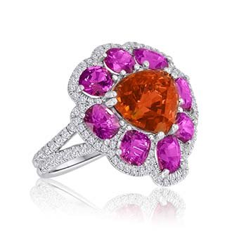 Garnet Spinel Ring: Mandarin garnet pear-shaped center, 12.00 tcw, surrounded by eight red spinels, 7.50 tcw, with 1.30 cara ts micro pave diamonds set in platinum.